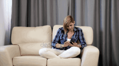 Woman Sitting On Couch Using Phone GIF