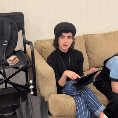 Woman Sitting On Couch Using Tablet With Abercrombie & Fitch Backpack GIF