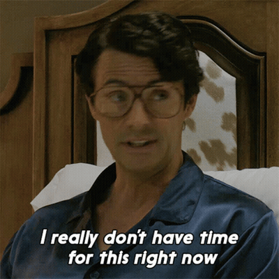 Woman Sitting On Couch With Arms Crossed Netflix Logo Behind GIF
