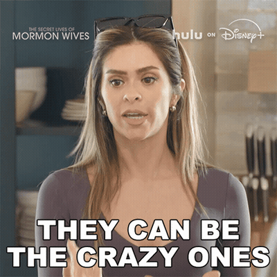 Woman Sitting On Couch With Blanket Saying The Secret Lives Of Mormon Wives GIF