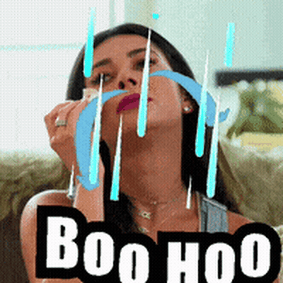 Woman Sitting On Couch With Boo Hoo Sign GIF