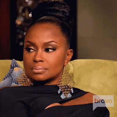 Woman Sitting On Couch With Bravo Logo GIF
