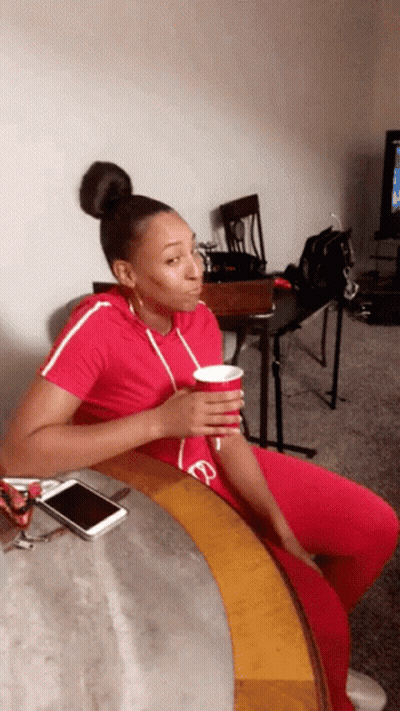Woman Sitting On Couch With Coffee GIF