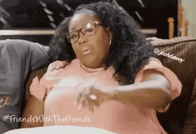 Woman Sitting On Couch With Glasses And Necklace GIF