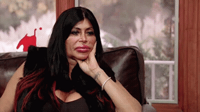 Woman Sitting On Couch With Hand On Chin GIF