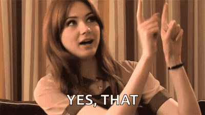 Woman Sitting On Couch With Hands Up GIF