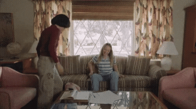 Woman Sitting On Couch With Man Standing Behind GIF