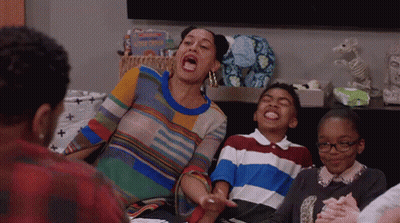 Woman Sitting On Couch With Mouth Open Surrounded By Children GIF