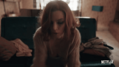 Woman Sitting On Couch With Netflix Logo GIF