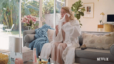 Woman Sitting On Couch With Netflix Tissues GIF