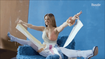 Woman Sitting On Couch With Outstretched Arms GIF