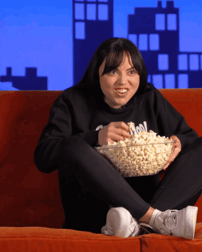 Woman Sitting On Couch With Popcorn GIF