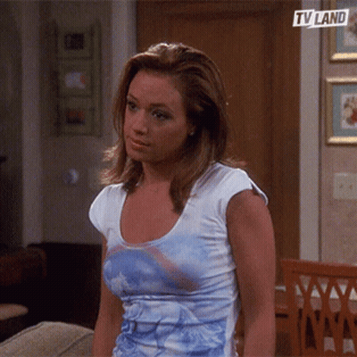 Woman Sitting On Couch With TV Land Logo GIF
