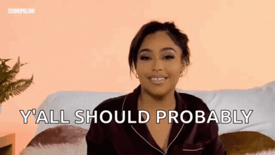 Woman Sitting On Couch With Y All Should Probably Behind Her GIF