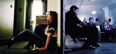Woman Sitting On Floor Next To Man In Chair GIF