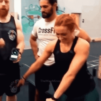Woman Sitting On Green Ball With Man Behind Her GIF