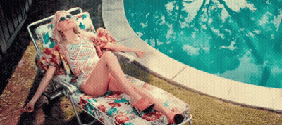 Woman Sitting On Lawn Chair By Pool GIF