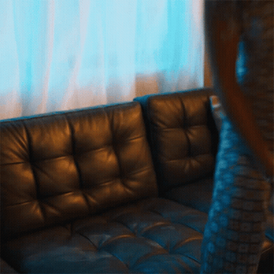 Woman Sitting On Leather Couch Legs Crossed GIF