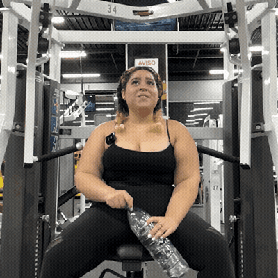 Woman Sitting On Machine With Aviso Sign GIF