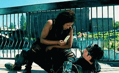 Woman Sitting On Man Lying On Ground GIF