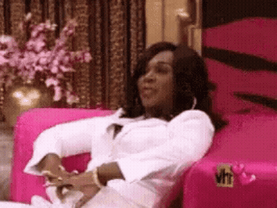 Woman Sitting On Pink Couch GIF