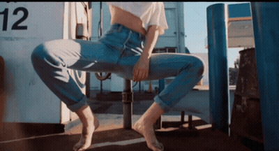 Woman Sitting On Pole With Number 12 GIF