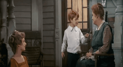 Woman Sitting On Porch Talking To Boy And Woman GIF