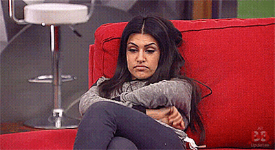 Woman Sitting On Red Couch With Arms Crossed Number 33 GIF