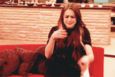 Woman Sitting On Red Couch With Brick Wall GIF