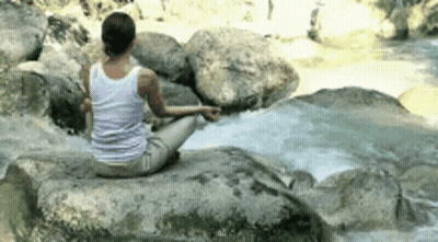 Woman Sitting On Rock By River GIF