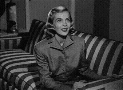 Woman Sitting On Striped Couch Looking GIF