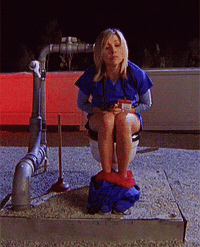 Woman Sitting On Toilet With Cup GIF
