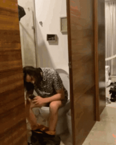 Woman Sitting On Toilet With Legs Crossed GIF
