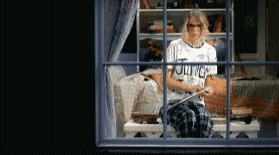 Woman Sitting On Window Sill Wearing Journey Shirt GIF