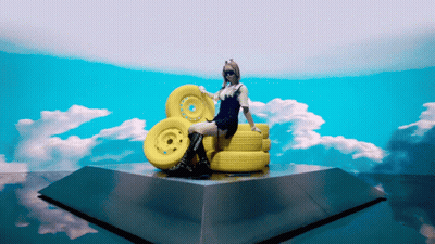 Woman Sitting On Yellow Wheels GIF