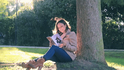 Woman Sitting Under Tree Reading Book With Star GIF