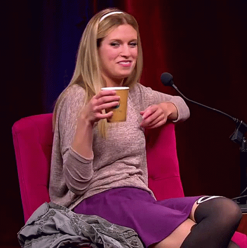 Woman Sitting With Cup Saying A GIF