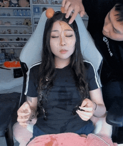 Woman Sitting With Egg On Forehead GIF