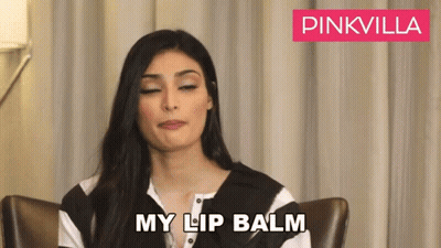 Woman Sitting With Eyes Closed And Lip Balm GIF
