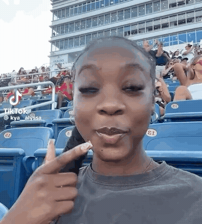 Woman Sitting With Eyes Closed And Making Face GIF