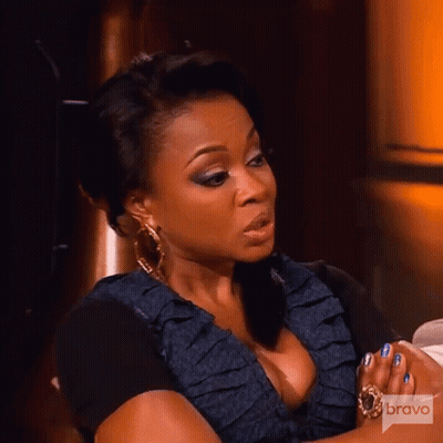 Woman Sitting With Folded Hands And Bravo Logo GIF