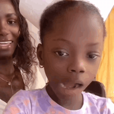 Woman Sitting With Little Girl In Purple Shirt GIF