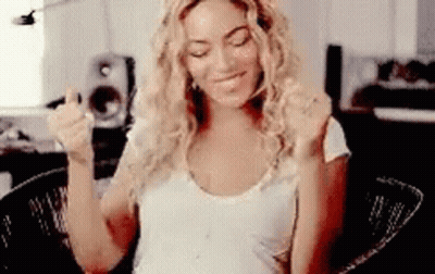 Woman Sitting With Outstretched Arms Making Funny Face GIF
