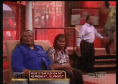 Woman Sitting With Provocative Sign GIF