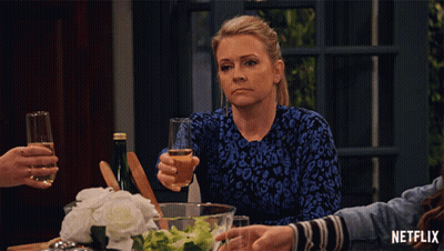 Woman Sitting With Wine And Netflix Logo GIF