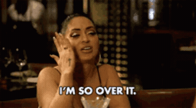 Woman Sitting With Wine Saying I'm Over It GIF