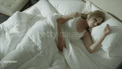 Woman Sleeping In Bed With White Sheets GIF