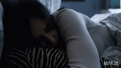 Woman Sleeping In Bed With Zebra Pillow And Netflix Logo GIF