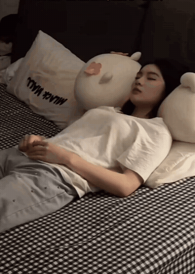 Woman Sleeping On Bed With Milk Mall Pillow GIF