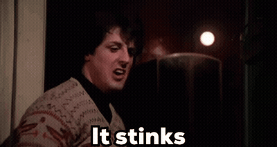 Woman Smelling In Dark Room Saying It Stinks GIF